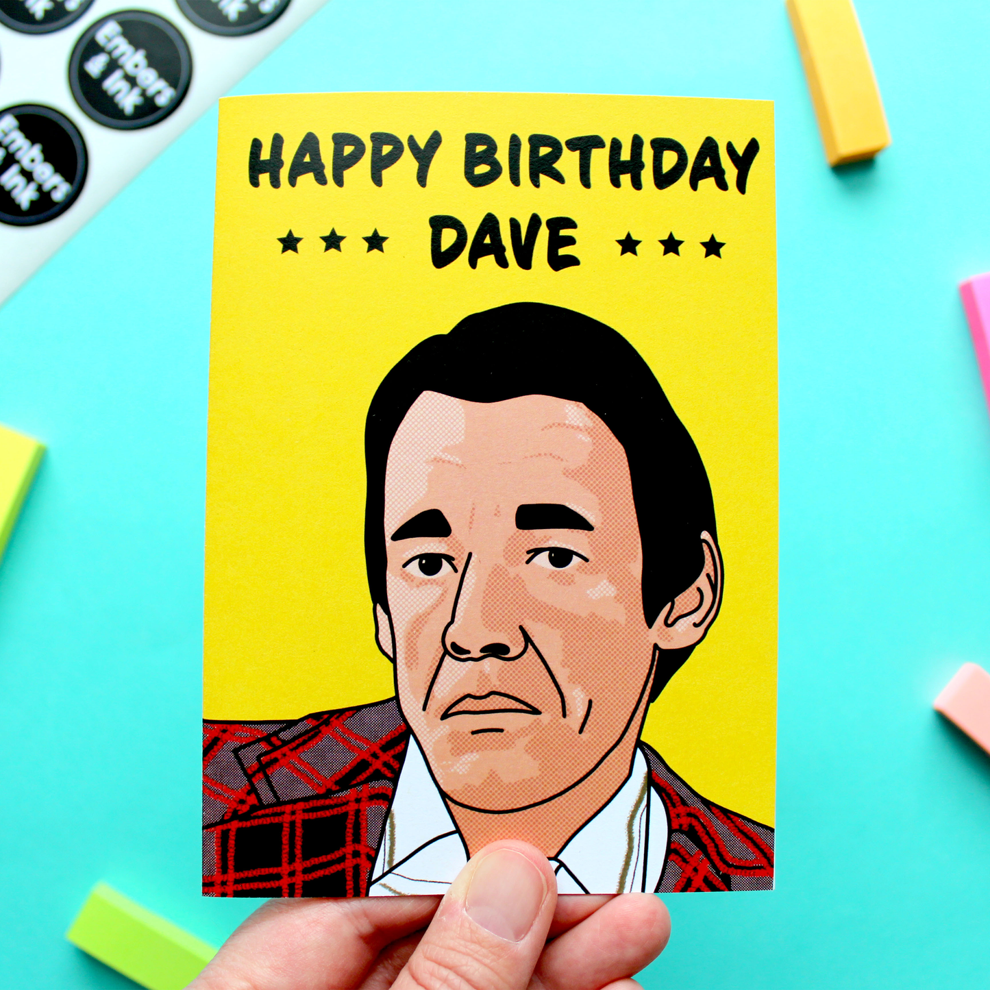 A hand holds a greetings card with a drawing of the character Trigger from the retro TV show Only Foold And Horses, under the words 'Happy Birthday Dave.'