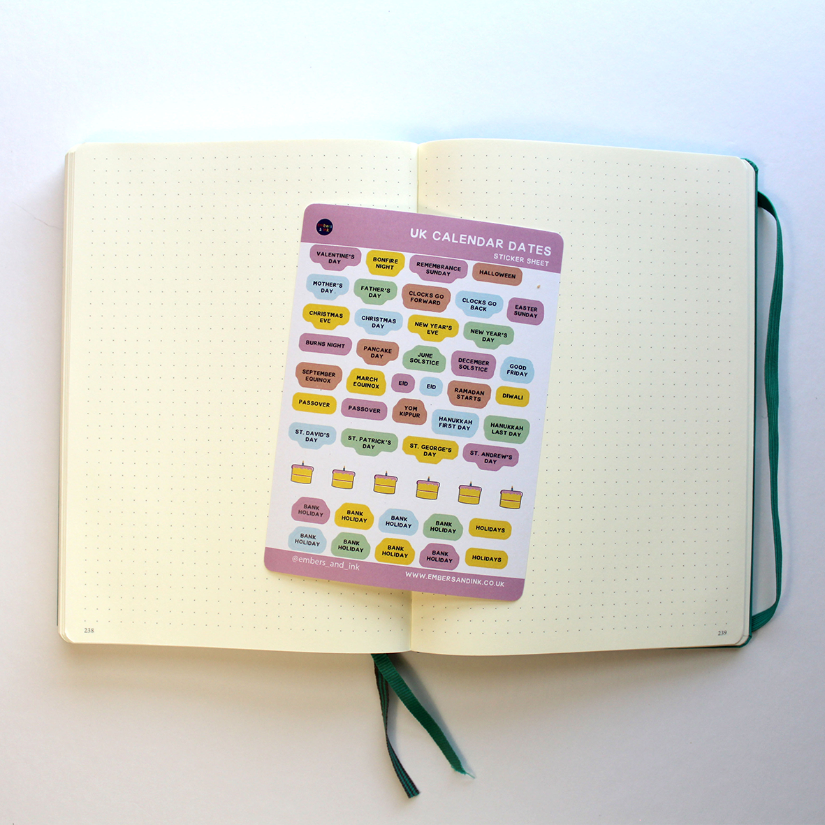 The sticker sheet is shown laying on top of the open pages of a blank planner, Ready for some Bullet Journalling.