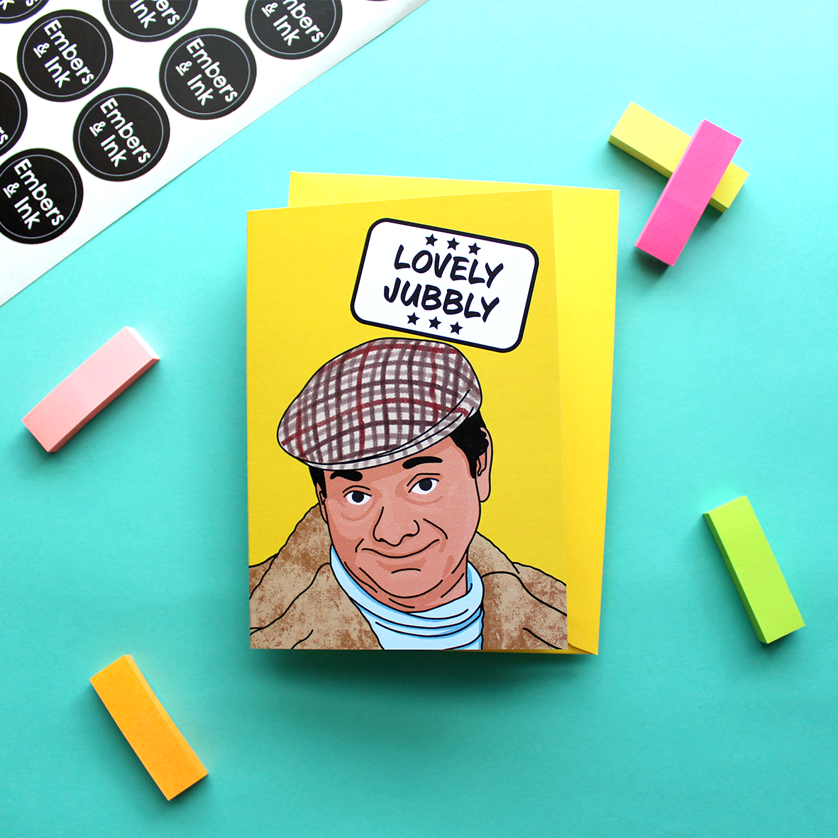 a yellow card with an illustration of Del Boy from a well known 80s TV programme. Above him in a white box are the words ‘Lovely Jubbly’