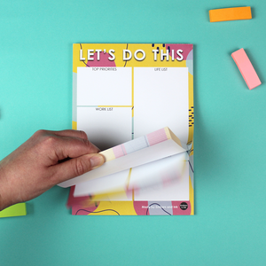 A hand flicks through the 50 pages of the notepad.