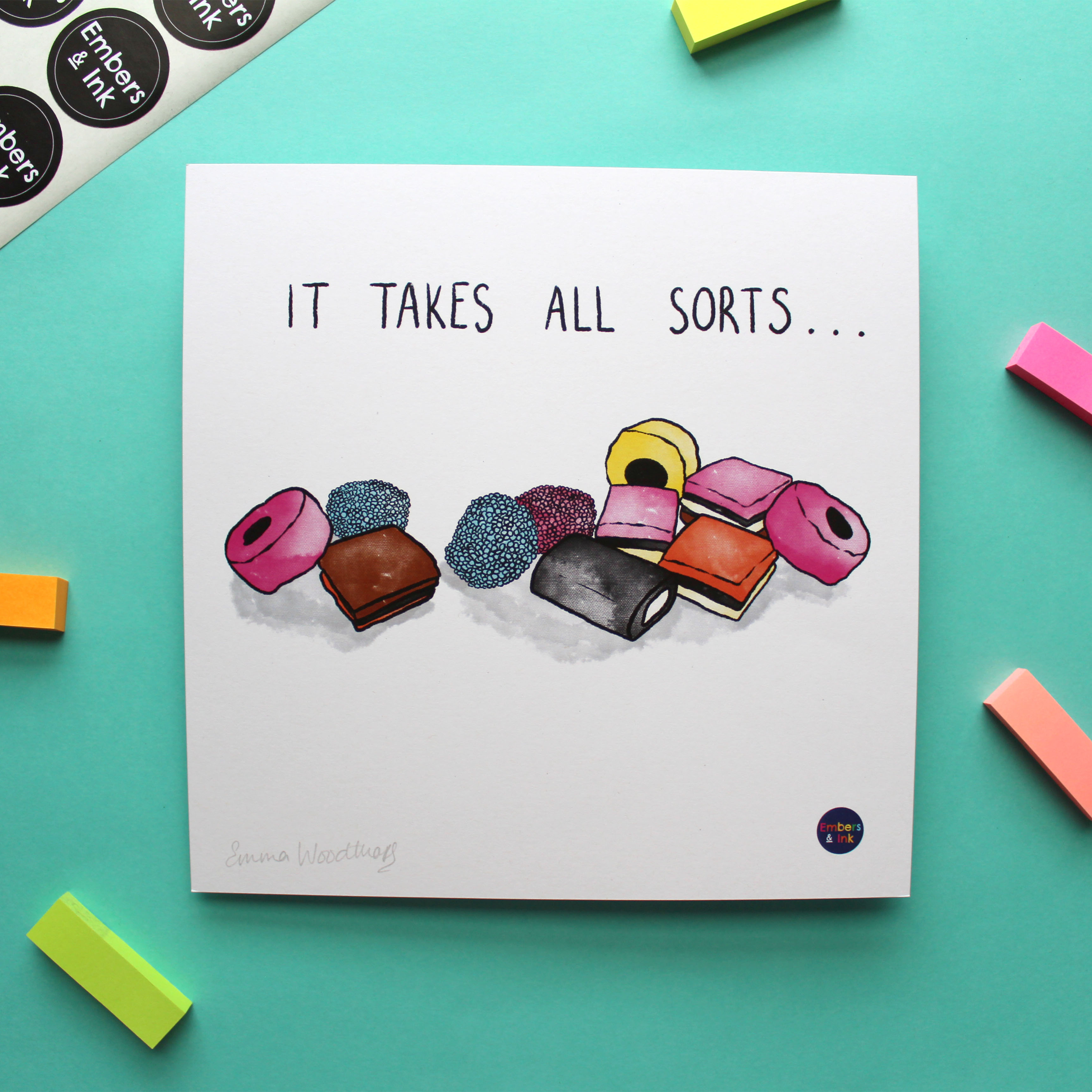 A square art print with an illustration of a pile of All Sorts sweets is shown. On the print, above the illustration, are the words 'it takes all sorts'