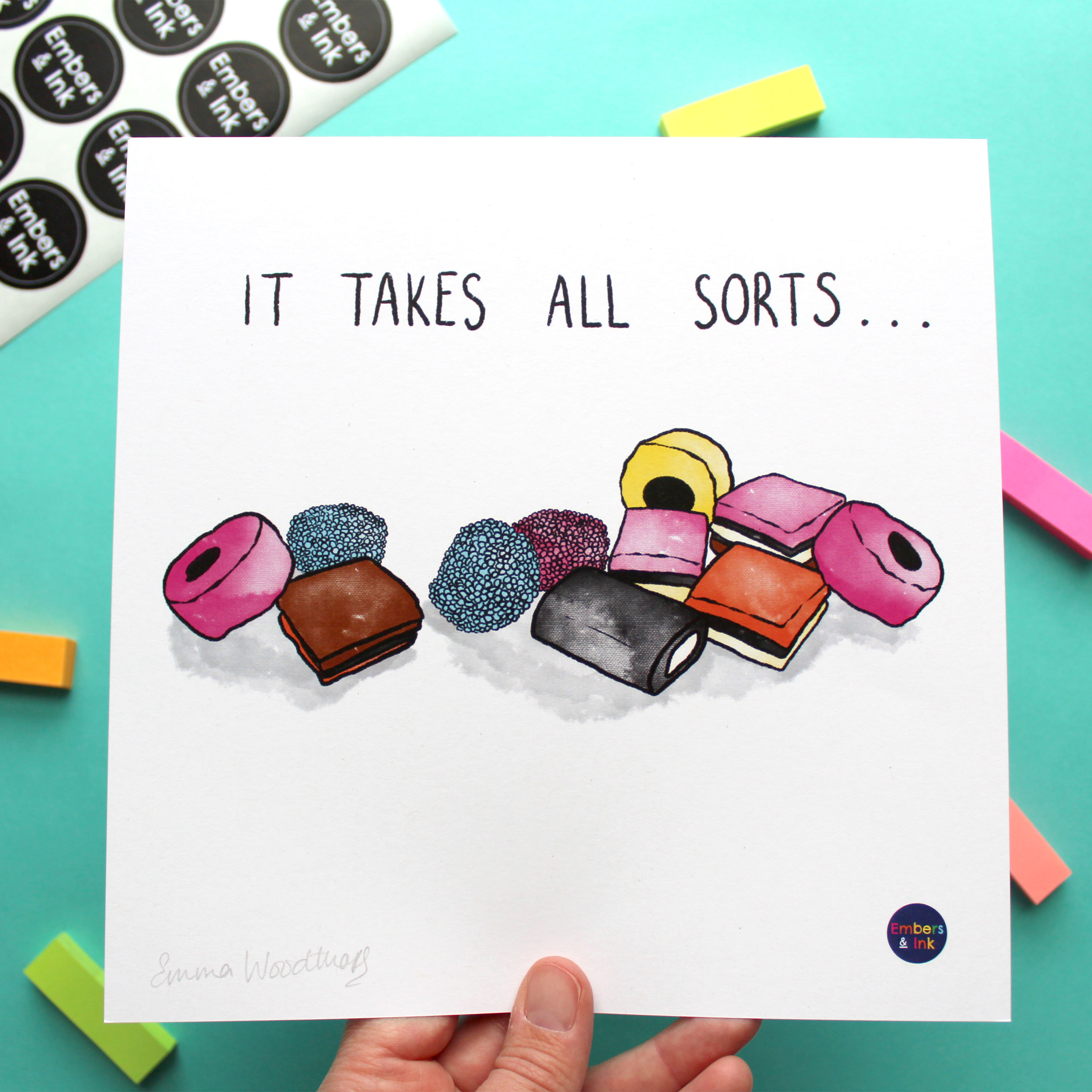 A square art print with an illustration of a pile of All Sorts sweets is shown. On the print, above the illustration, are the words 'it takes all sorts'