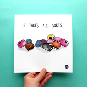 A square art print with an illustration of a pile of All Sorts sweets is shown. On the print, above the illustration, are the words 'it takes all sorts'