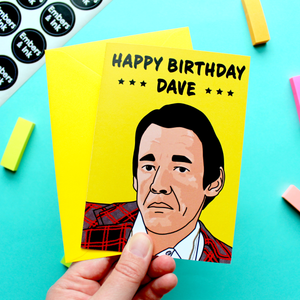 A hand holds a greetings card with a drawing of the character Trigger from the retro TV show Only Foold And Horses, under the words 'Happy Birthday Dave.'