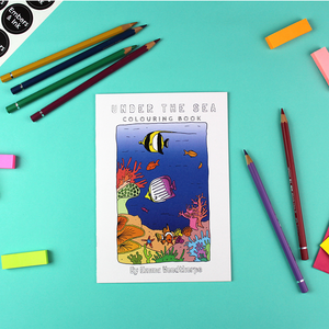 The under the sea colouring book is shown on the table surrounded by coloured pencils.