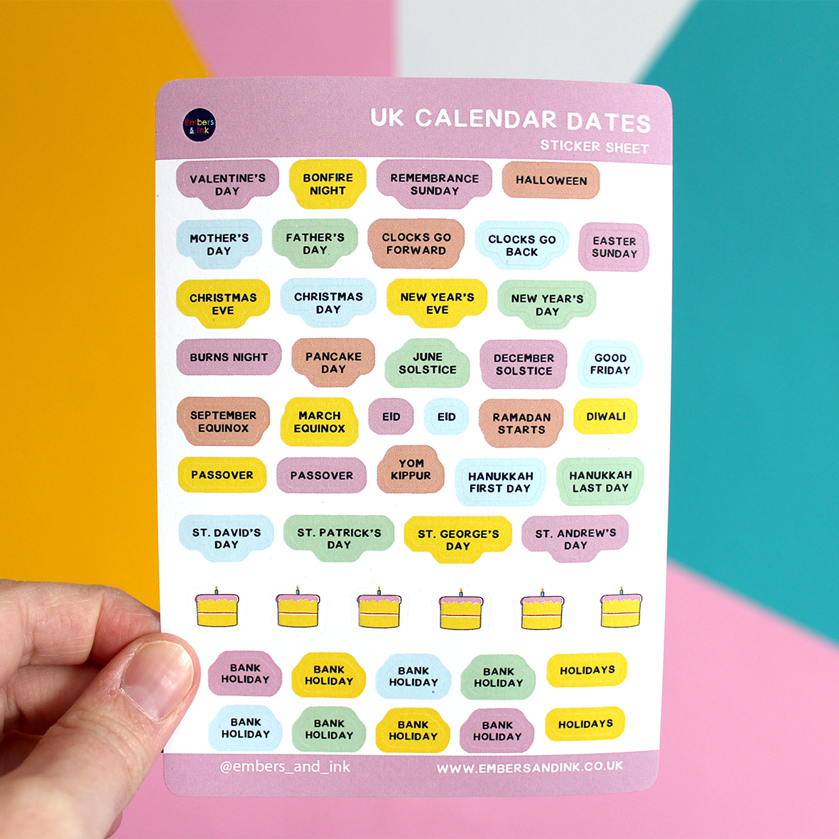 A hand holds up the sticker sheet in front of a colourful wall