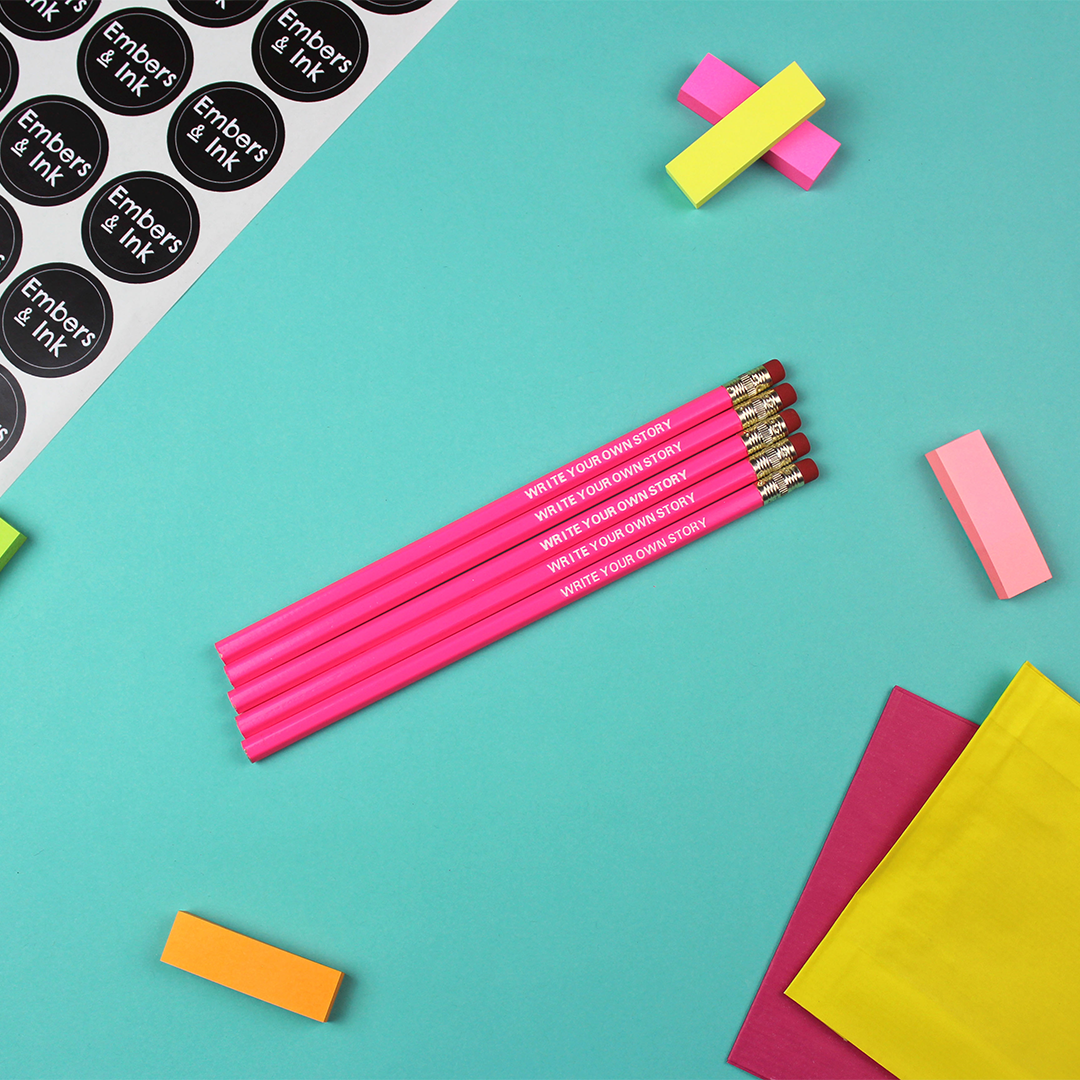 A collection of 5 'write your own story'pencils rest on a table